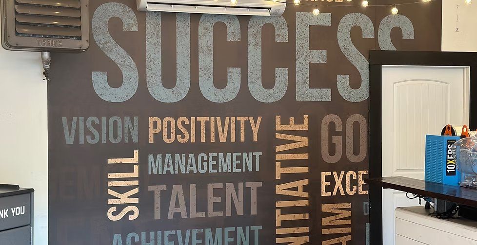 Large SUCCESS motivational word-wall mural in a commercial office