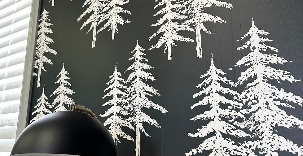 White pine trees silhouetted on a deep green feature wall