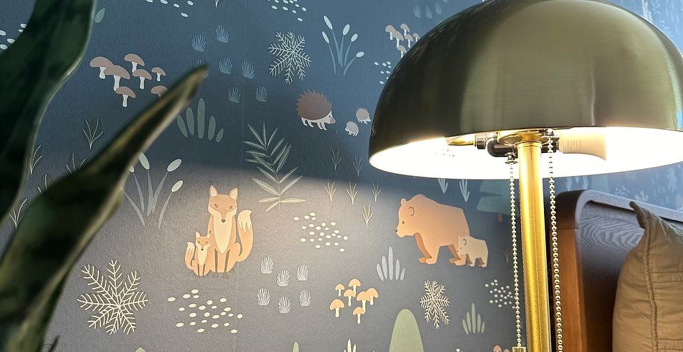 Navy woodland-animal wallpaper with foxes and bears in a nursery